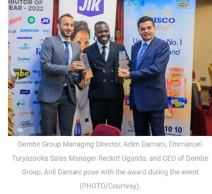 Dembe Group Managing Director, Adim Damani, Emmanuel Turyazooka sales manager Reckitt Uganda and the CEO of Dembe Group, Anil Damani pose with the award during the East Africa Brand Quality Awards