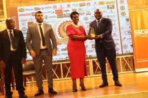 Hon. Amelia Kyambadde together with Amb. Mohammad and Dr. Emeka Akaezuwa presenting an accolade to Stabex International Head of Marketing Mr. Gilbert Otim