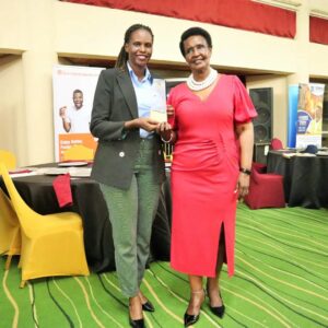 Ms. Sharon from Biyinzika Poutry Bleeders Limited together with Hon. Amelia Kyambadde celebrating after receiving an award at the East Africa Brand Quality Awards 2022