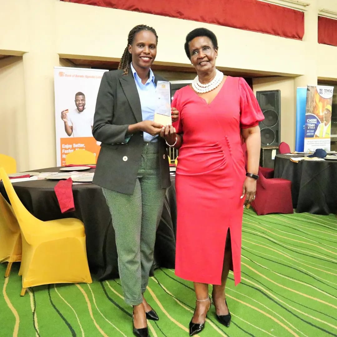 Ms. Sharon from Biyinzika Poutry Bleeders Limited together with Hon. Amelia Kyambadde celebrating after receiving an award at the East Africa Brand Quality Awards 2022
